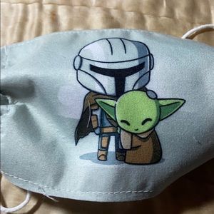 Mando petting Yoda Mask